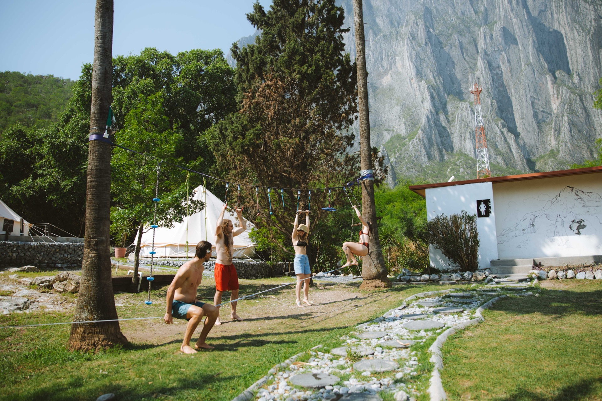 Grupo de amigos jugando en el jardín junto a las tiendas